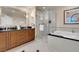This bathroom features a soaking tub, glass shower, and dual vanity at 125 E Harmon Ave # 511, Las Vegas, NV 89109