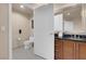 Bathroom featuring tile flooring, vanity with sink and a toilet behind an open white door at 125 E Harmon Ave # 511, Las Vegas, NV 89109