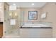 Luxurious bathroom featuring a large soaking tub, walk-in glass shower, and neutral tile at 125 E Harmon Ave # 511, Las Vegas, NV 89109