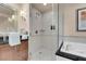 Elegant bathroom featuring a glass-enclosed shower with toiletries and a luxurious soaking tub at 125 E Harmon Ave # 511, Las Vegas, NV 89109
