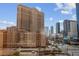 City view featuring street with cars, tall buildings and beautiful blue skies at 125 E Harmon Ave # 511, Las Vegas, NV 89109