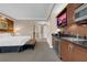 This kitchenette features a microwave, sink, mini fridge, and TV in the bedroom at 125 E Harmon Ave # 511, Las Vegas, NV 89109