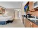 Functional kitchenette area boasting modern appliances, a television, and convenient access at 125 E Harmon Ave # 511, Las Vegas, NV 89109