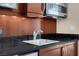 A close-up of the kitchenette featuring a microwave, sink, and mini fridge at 125 E Harmon Ave # 511, Las Vegas, NV 89109