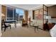 Bright living room featuring a sitting area, desk, and large windows with city views at 125 E Harmon Ave # 511, Las Vegas, NV 89109