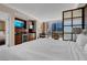 Bright main bedroom featuring a kitchenette, sitting area, desk, and large windows with city views at 125 E Harmon Ave # 511, Las Vegas, NV 89109