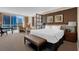 Bright main bedroom featuring a king bed, sitting area, desk, and large windows with city views at 125 E Harmon Ave # 511, Las Vegas, NV 89109