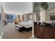 Bright and spacious main bedroom featuring a sitting area, desk, bar area, and large windows with city views at 125 E Harmon Ave # 511, Las Vegas, NV 89109