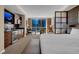 Bright main bedroom featuring a kitchenette, sitting area, desk, and large windows with city views at 125 E Harmon Ave # 511, Las Vegas, NV 89109