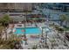 A luxurious pool area with lounge chairs, lush landscaping, and city views creates a relaxing oasis at 125 E Harmon Ave # 511, Las Vegas, NV 89109
