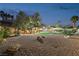 Spacious backyard with a balcony, outdoor seating, a well-maintained pool, and a drought-resistant rock garden at 1251 Los Meadows Dr, Las Vegas, NV 89110