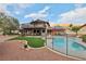 The backyard features a refreshing pool, grassy area, upper deck, and a desert landscape at 1251 Los Meadows Dr, Las Vegas, NV 89110