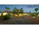 Expansive backyard featuring mature trees, gravel landscaping, and a charming balcony, perfect for outdoor enjoyment at 1251 Los Meadows Dr, Las Vegas, NV 89110