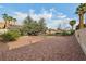 Expansive backyard with gravel, mature trees, lawn, pool, and a second story deck at 1251 Los Meadows Dr, Las Vegas, NV 89110