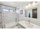 Modern bathroom features marble-tiled shower, tub, and a sleek vanity area at 1251 Los Meadows Dr, Las Vegas, NV 89110