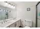 The bathroom has a shower, toilet, a double sink, and a large mirror with overhead lighting at 1251 Los Meadows Dr, Las Vegas, NV 89110