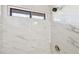 Marble tiled shower stall features a window, modern fixtures, and clean finishes at 1251 Los Meadows Dr, Las Vegas, NV 89110