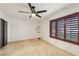 An empty bedroom with tiled floors and a window with wooden shutters at 1251 Los Meadows Dr, Las Vegas, NV 89110