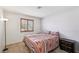Comfortable bedroom with carpet, window with shutters and Southwestern style bedspread at 1251 Los Meadows Dr, Las Vegas, NV 89110