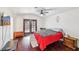 Spacious bedroom with rich wood floors, ceiling fan, and stylish furnishings at 1251 Los Meadows Dr, Las Vegas, NV 89110
