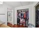 Walk-in closet located adjacent to the bathroom has an abundance of clothing and personal items at 1251 Los Meadows Dr, Las Vegas, NV 89110