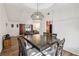 Open dining room with hardwood floors and a large wooden table under a pendant light at 1251 Los Meadows Dr, Las Vegas, NV 89110