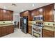 A full kitchen with stainless steel appliances and stunning granite countertops at 1251 Los Meadows Dr, Las Vegas, NV 89110