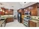 Kitchen with granite countertops, stainless steel appliances, and tile flooring at 1251 Los Meadows Dr, Las Vegas, NV 89110