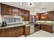 Well-lit kitchen with cherry cabinets and granite countertops at 1251 Los Meadows Dr, Las Vegas, NV 89110