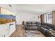 Well-lit living room with hardwood floors, a sectional couch and wall-mounted TV at 1251 Los Meadows Dr, Las Vegas, NV 89110