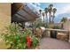 Outdoor kitchen with built-in grill, stone counter, and a lush garden featuring a bright red fire hydrant at 1251 Los Meadows Dr, Las Vegas, NV 89110