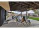 Covered patio features an outdoor seating area with a ceiling fan, overlooking the backyard and pool at 1251 Los Meadows Dr, Las Vegas, NV 89110