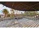 A covered deck area showcasing a spacious wooden patio with a privacy lattice and string lights at 1251 Los Meadows Dr, Las Vegas, NV 89110