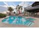 Backyard pool area with lush landscaping and view of the balcony, perfect for outdoor entertaining at 1251 Los Meadows Dr, Las Vegas, NV 89110