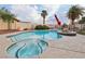 Inviting backyard pool and spa area with surrounding palm trees, patio, and lounge space at 1251 Los Meadows Dr, Las Vegas, NV 89110