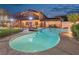 Beautiful pool with integrated spa, surrounded by lush landscaping and an iron fence, offering a private retreat at 1251 Los Meadows Dr, Las Vegas, NV 89110