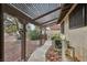 Covered walkway leads to a custom outdoor kitchen and backyard; gravel ground cover for easy care at 1251 Los Meadows Dr, Las Vegas, NV 89110