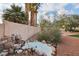 Backyard water feature with decorative rocks, plants, and accent lighting for a tranquil outdoor space at 1251 Los Meadows Dr, Las Vegas, NV 89110