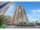 Stunning exterior shot of a high-rise condo building in Las Vegas, Nevada with a circular driveway and manicured landscaping at 135 E Harmon Ave # 1403, Las Vegas, NV 89109