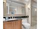 Bathroom features a glass-enclosed shower, vanity with dark countertops, and a large mirror at 135 E Harmon Ave # 1621, Las Vegas, NV 89109