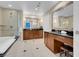 Bathroom featuring a soaking tub, walk-in shower with glass enclosure, and modern vanity with ample counter space at 135 E Harmon Ave # 1621, Las Vegas, NV 89109