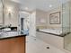 Well-lit bathroom showcasing modern vanity, soaking tub with tile surround, and glass-enclosed shower at 135 E Harmon Ave # 1621, Las Vegas, NV 89109