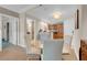 Dining area features a glass table, modern chairs, and an adjacent kitchen area at 135 E Harmon Ave # 1621, Las Vegas, NV 89109