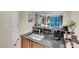 Modern kitchenette with dark countertops, and adjacent dining and living spaces at 135 E Harmon Ave # 1621, Las Vegas, NV 89109
