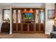 Living room boasts a built-in entertainment center, complete with a TV, complemented by a nearby seating area at 135 E Harmon Ave # 1621, Las Vegas, NV 89109