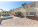 Relax in a backyard with a pool, outdoor kitchen, covered patio, and paver patio at 1502 Oxbow Ct, Henderson, NV 89014