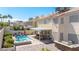 Backyard includes a pool, spa, paver patio, lush greenery, and a covered outdoor seating area at 1502 Oxbow Ct, Henderson, NV 89014