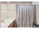 Bathroom featuring a modern sink, and a bathtub with a grey shower curtain at 1502 Oxbow Ct, Henderson, NV 89014