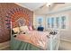 Charming bedroom featuring a bed, ceiling fan, and ample natural light through windows at 1502 Oxbow Ct, Henderson, NV 89014