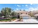Beautiful two-story home featuring manicured landscaping, a spacious driveway, and a charming front entrance at 1502 Oxbow Ct, Henderson, NV 89014